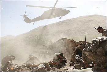 A helicopter lands to remove wounded soldiers of the U.S. Army's Apache Company, 2nd Battalion 87th Infantry Regiment, part of the 3rd Combat Brigade 10th Mountain Division based out of Fort Drum, N.Y., after their armored vehicle was hit by an improvised explosive device in the Tangi Valley of Afghanistan's Wardak Province, Wednesday Aug. 19, 2009. (AP Photo/David Goldman)
